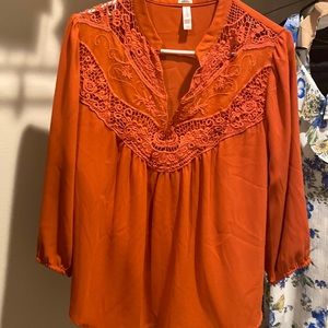 Ladies rust colored blouse.